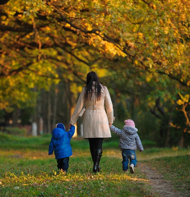 mother with children twins on a walk in the autumn park